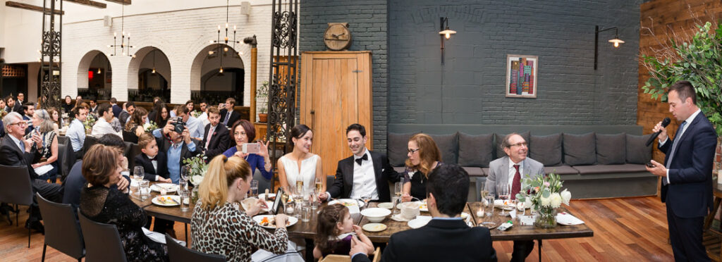 A group of people sitting at tables in a large room in the restaurant The Milling Room.