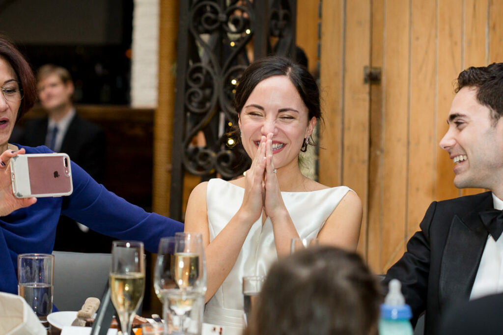 A group of people clapping at a wedding reception.