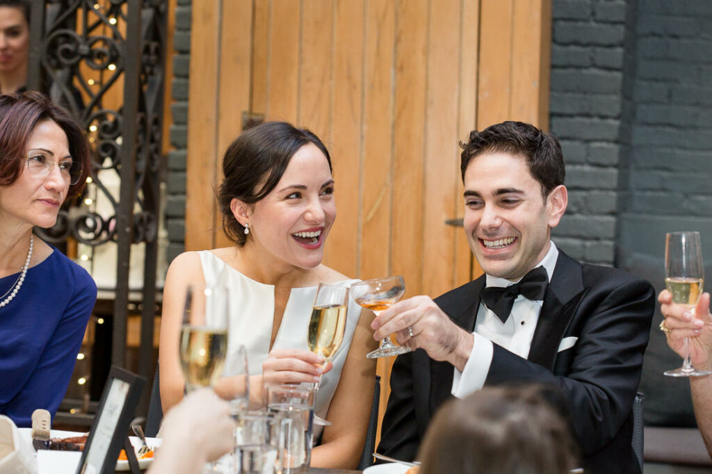 A group of people toasting at a dinner party.