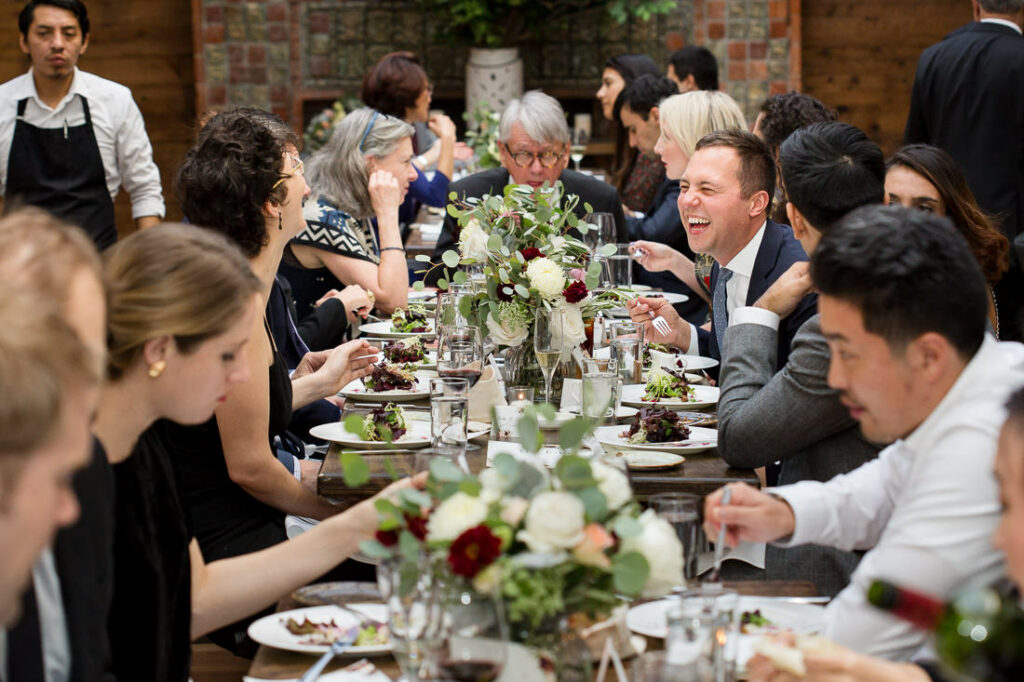 A group of people sitting at a long table at the New York resturant The Milling Room.