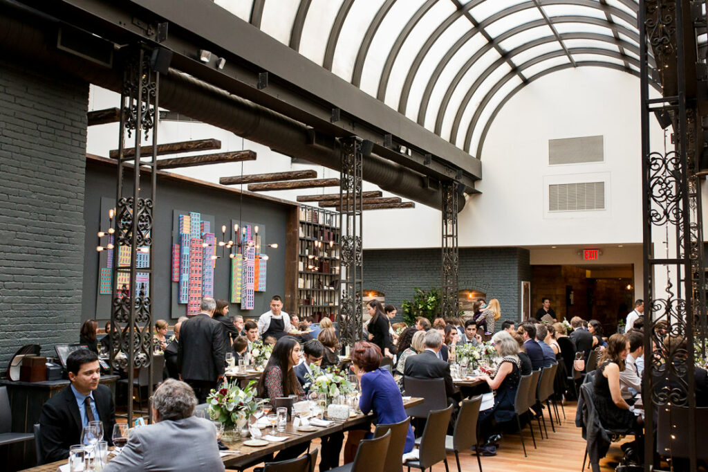 A group of people are sitting at tables at The Milling Room.