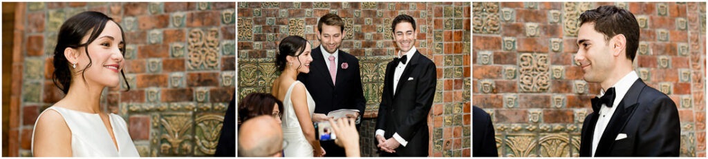 A bride and groom looking at each other in front of a brick wall.