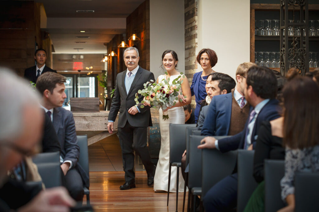A bride and groom walking down the aisle at a wedding at The Milling Room.