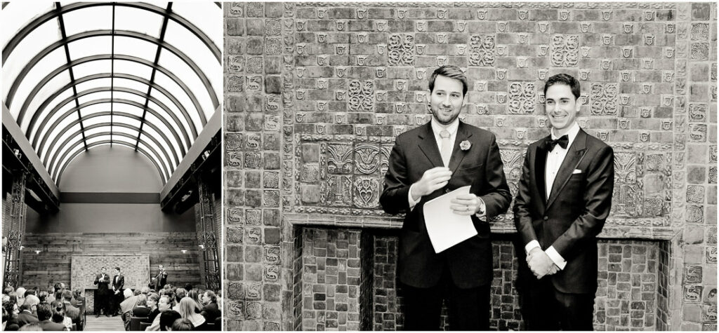 A black and white photo of two men standing in front of a brick wall.