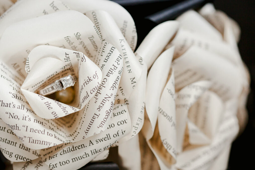 Exquisite paper roses adorned with a delicate ring at their center.