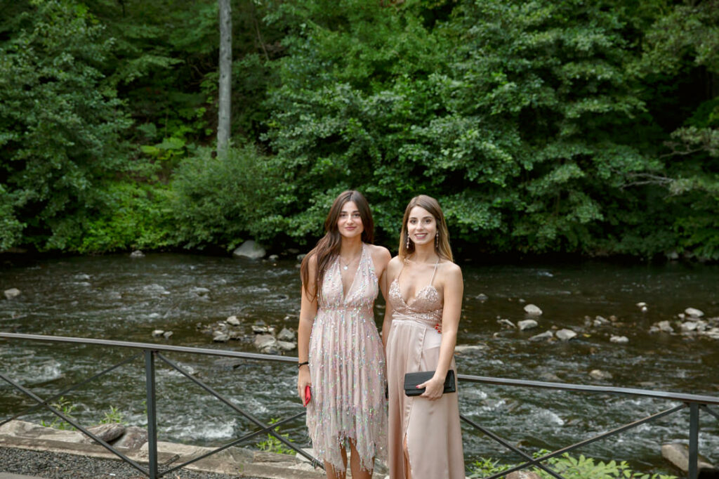 Two women standing on a bridge near the New York Botanical Garden.