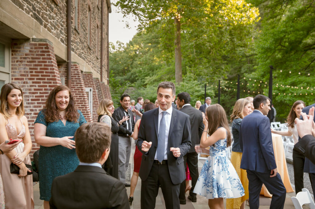 A group of people at an outdoor wedding at the New York Botanical Garden.