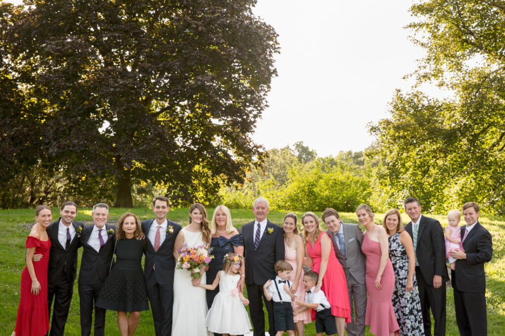 A wedding party posing for a photo at the New York Botanical Garden.