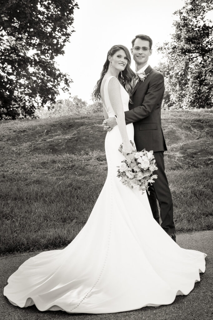 A bride and groom posing for a photo in the New York Botanical Garden.