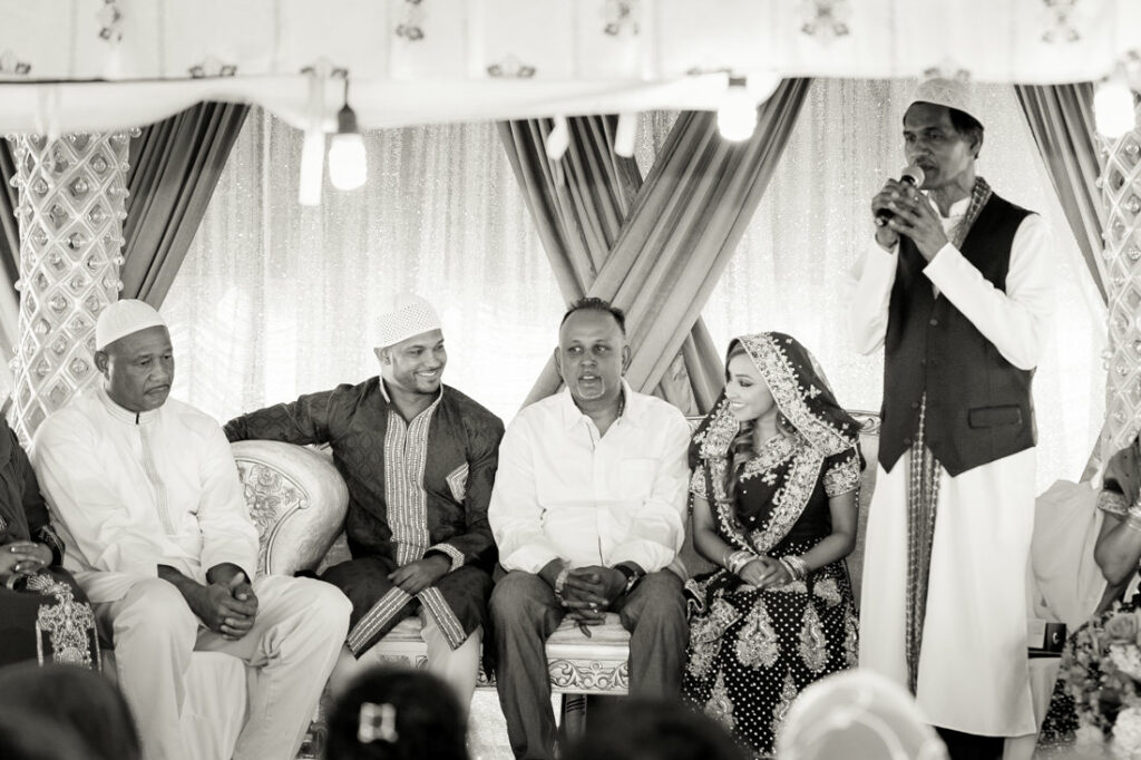 A black and white photo of a group of people at a nikah wedding.