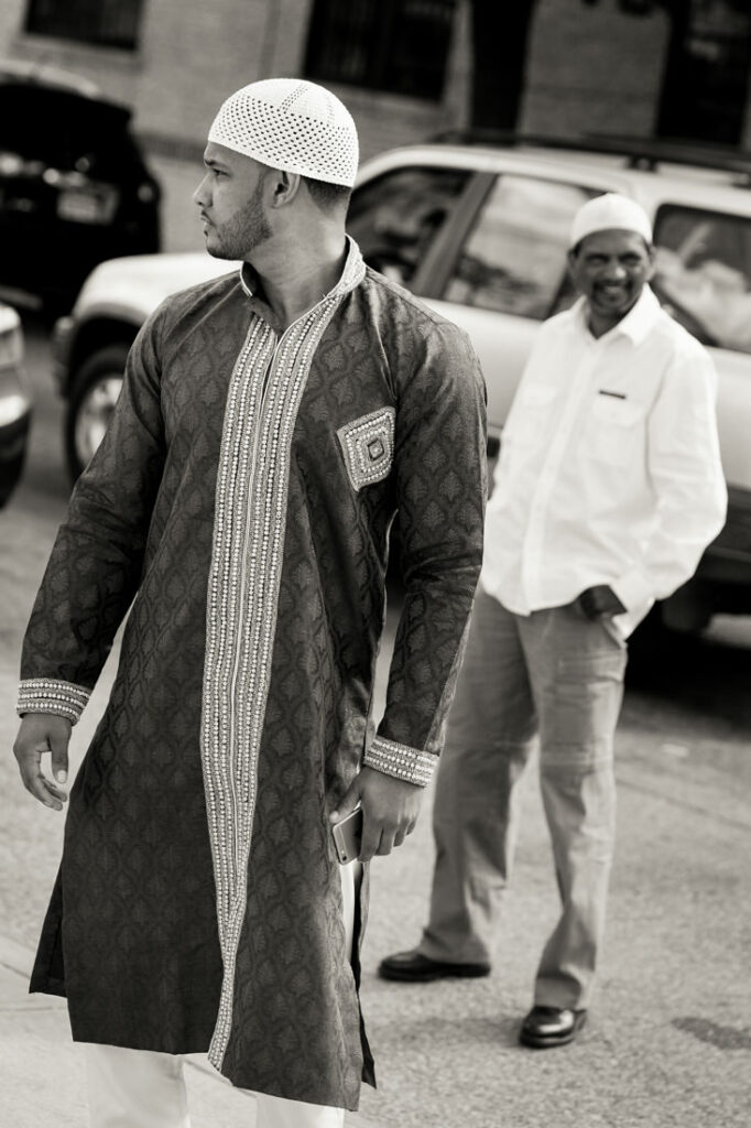 A man in a nikah outfit is walking down the street.