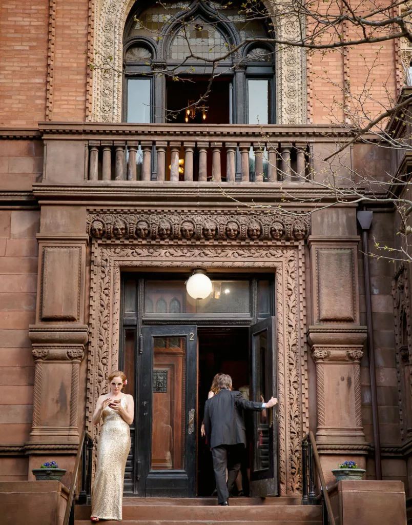 A bride standing on the steps of a The Montauk Club building.