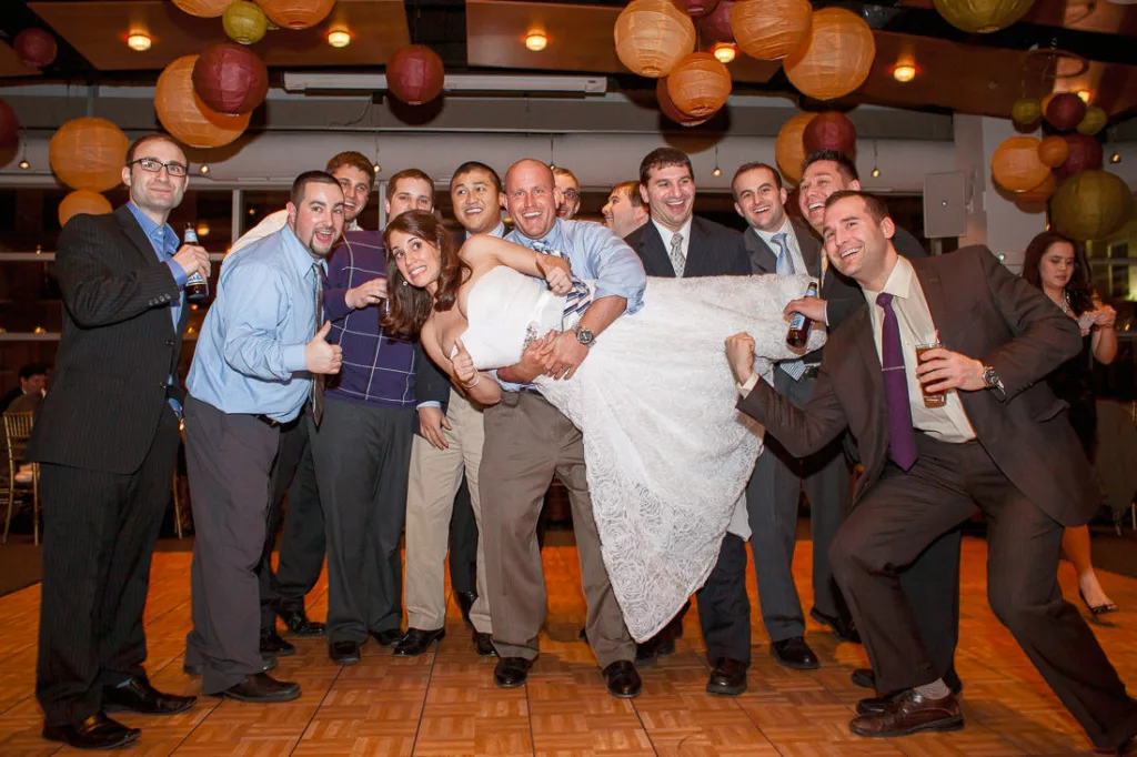 A group of people posing for a picture at a wedding at VisArts.