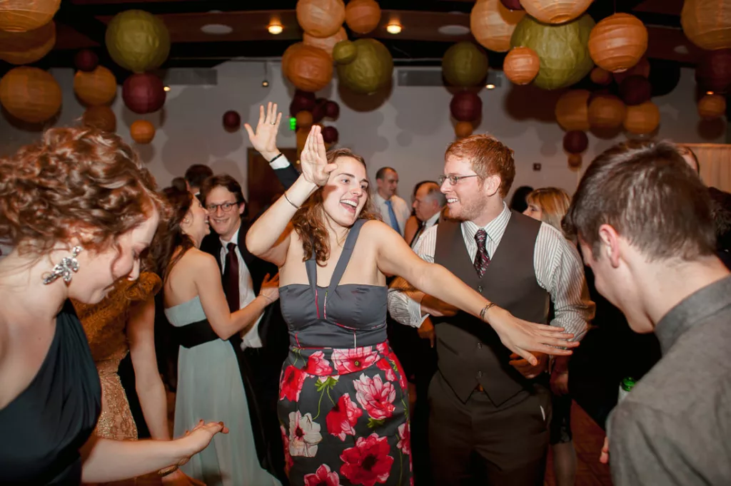 A group of people dancing at a party.