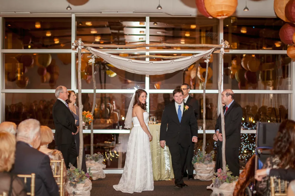 A bride and groom walk down the aisle at a wedding ceremony.