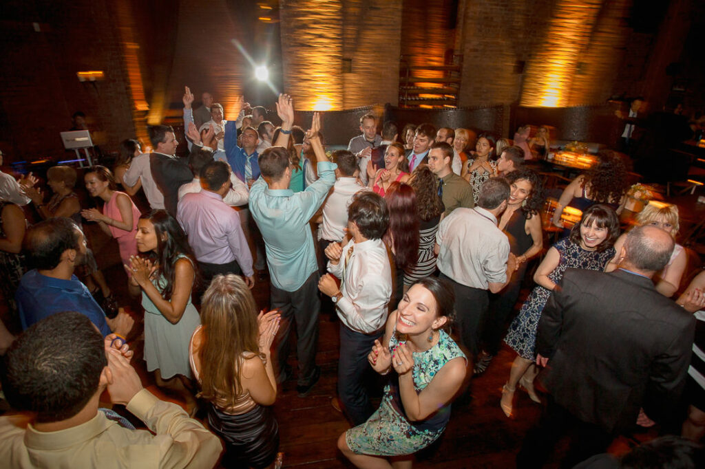 A lively group dancing at a party beneath the mesmerizing glow of mymoon.