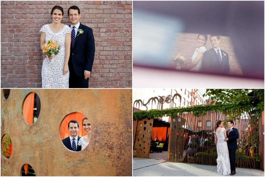 A bride and groom are posing in front of a brick wall for their #mymoon wedding photo.