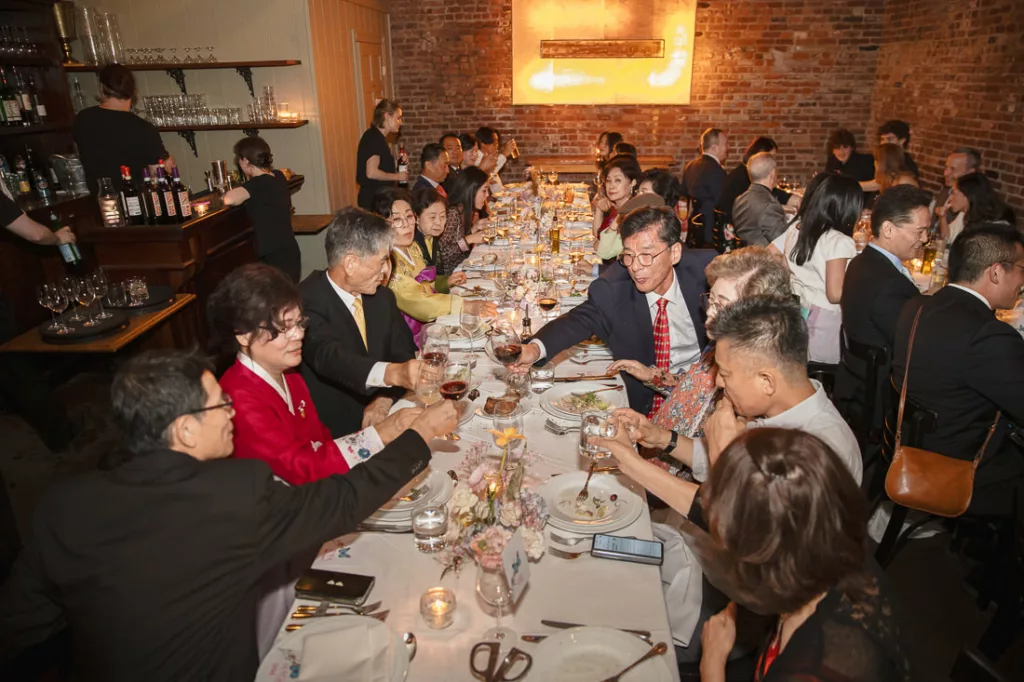 A group of people sitting around a long table at Frankies 457 Spuntino.