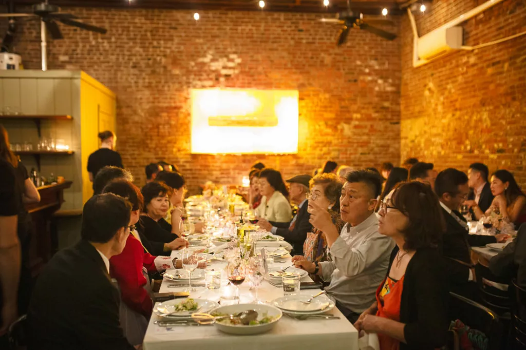 A group of people sitting at a table at Frankies 457 Spuntino.