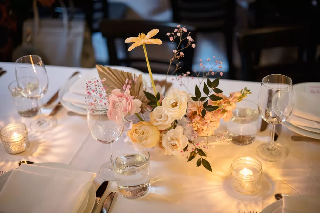 A table setting with candles and flowers on it at Frankies 457 Spuntino.