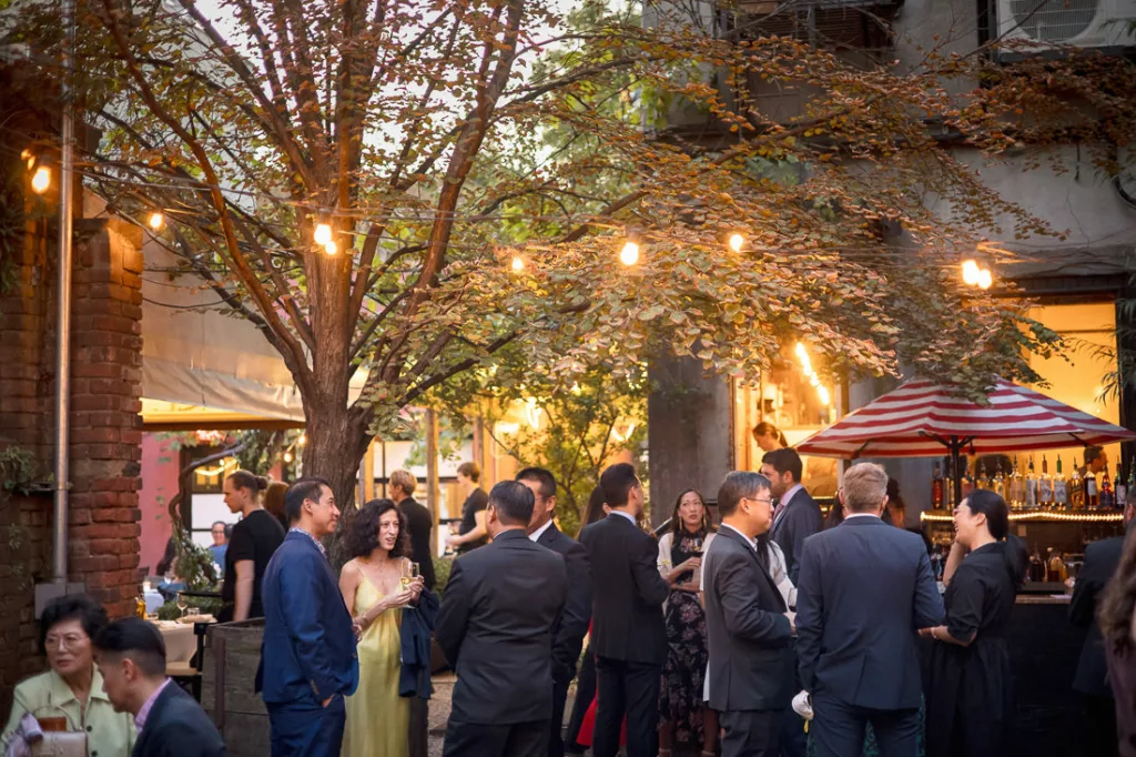 A group of people standing around at an outdoor event.