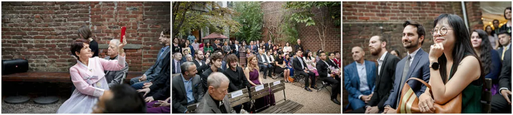A group of people standing in front of a brick wall.