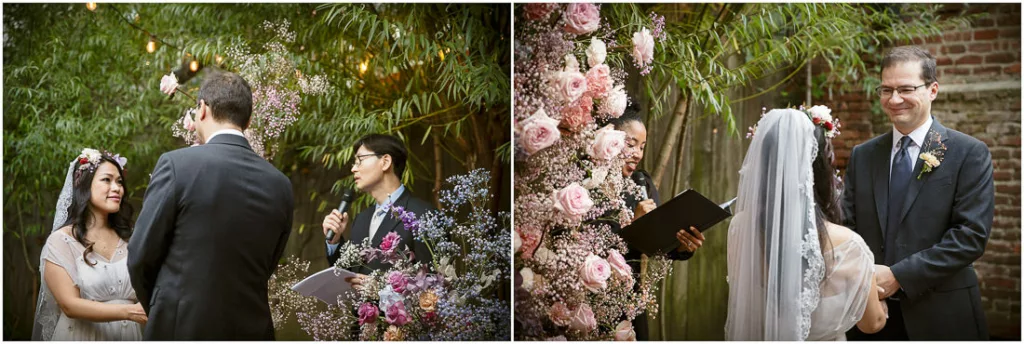 A bride and groom exchange vows in front of flowers.