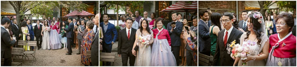 A bride walking down the aisle with her parents.