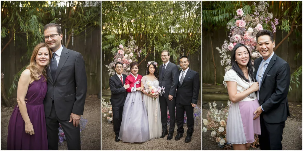 A group of people posing in front of a flower garden.