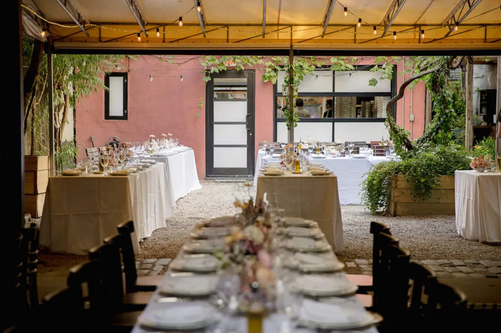 An outdoor wedding reception set up with tables and chairs at Frankies 457 Spuntino.