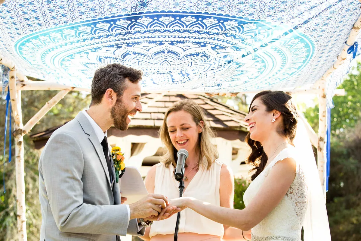 A bride and groom are exchanging vows at a wedding ceremony.