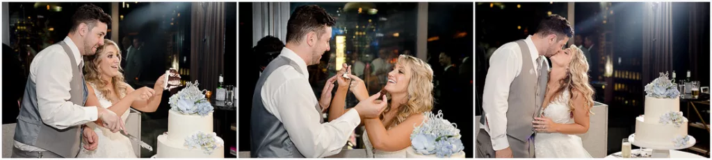 A bride and groom cutting their wedding cake in front of a city skyline.