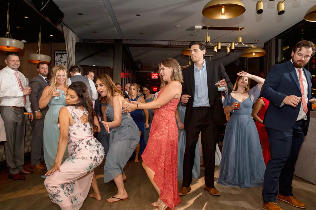 A group of people dancing at a wedding reception at The Skylark in NYC.