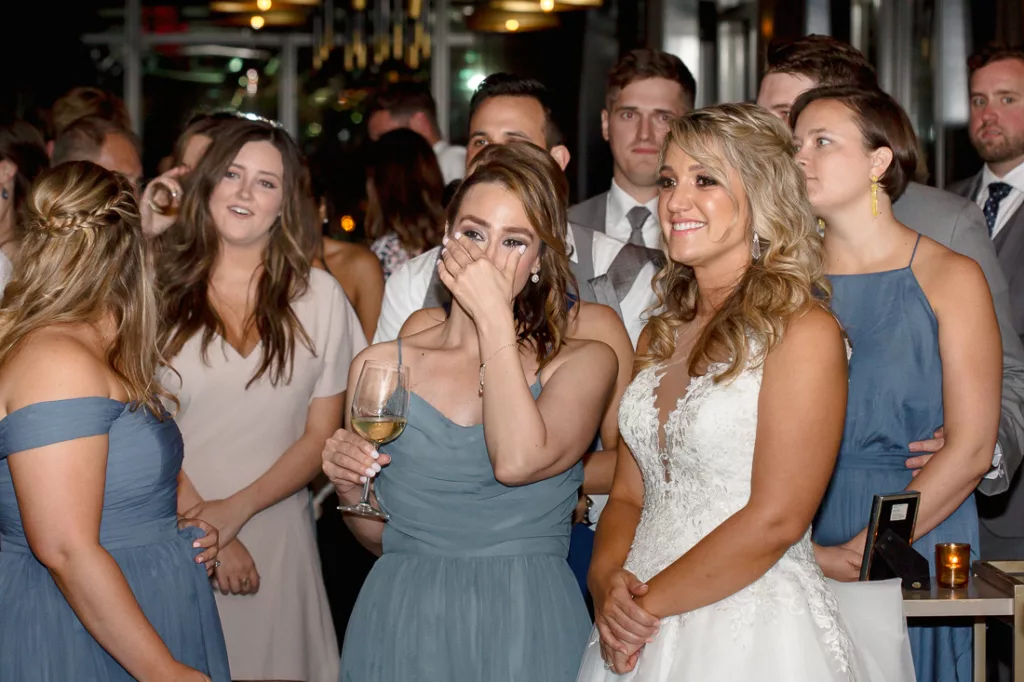 A group of bridesmaids laughing at a wedding reception at The Skylark in NYC.