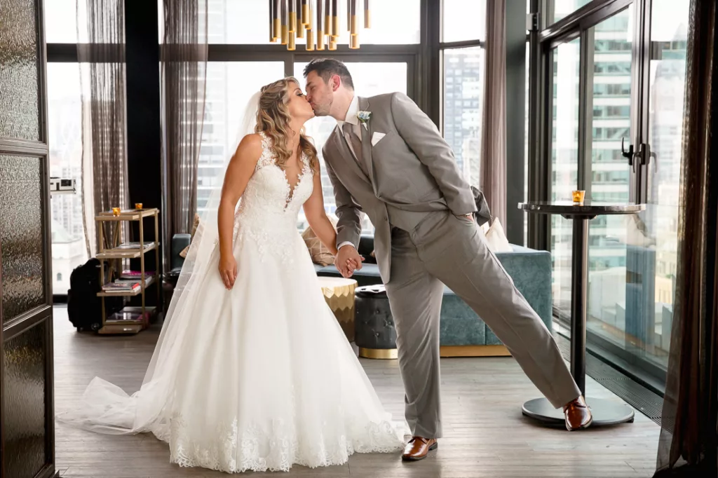 A man and woman kissing in a room.