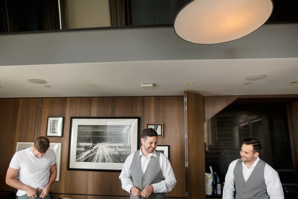 Three men standing in front of a kitchen in a hotel.